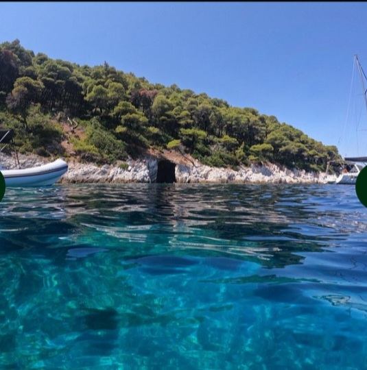 Turquoise cove beneath wooded slopes