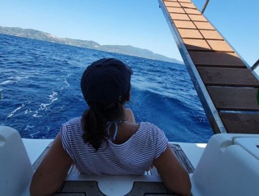 A guest enjoying the open sea from the bow under way