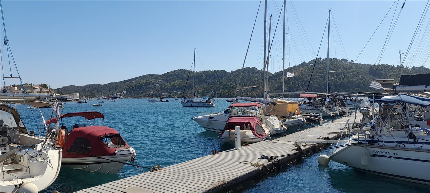 Yachts moored along the floating pier at Skiathos New Port
