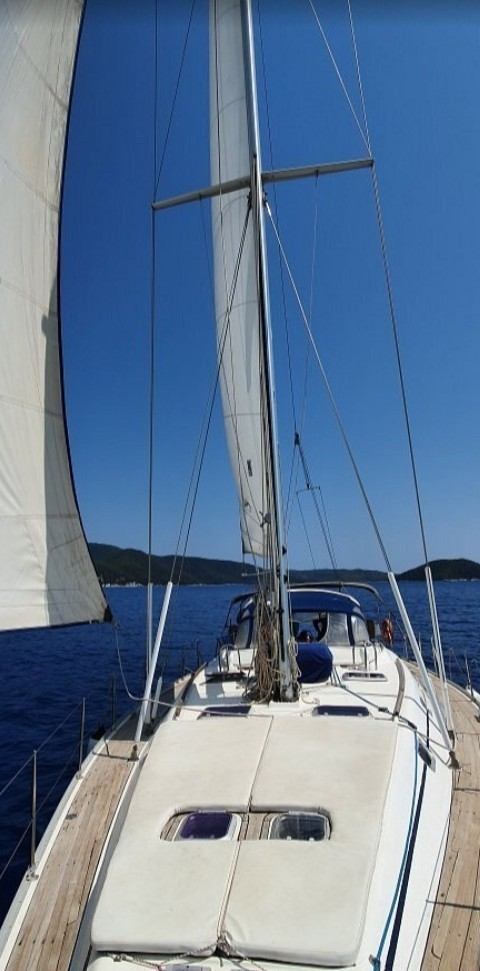 White sails set against the blue sky under way