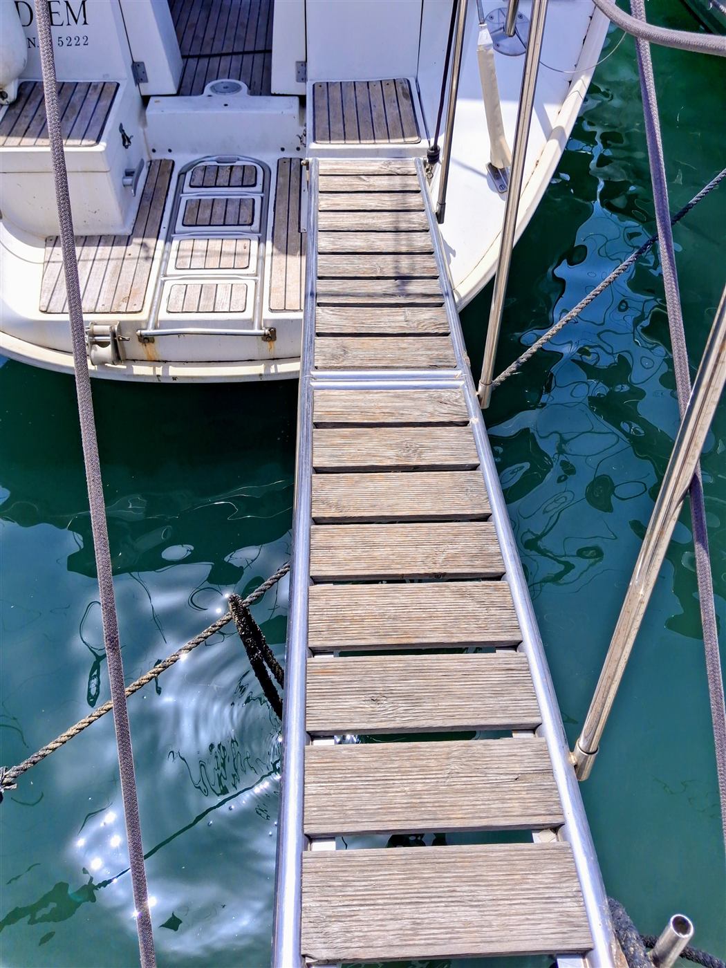 Wooden gangway leading aboard Carpe Diem at the floating pier